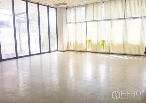 Warehouse for rent in Bang Phli, Samut Prakan - Glass-fronted office or showroom area with floor-to-ceiling windows and vertical blinds.