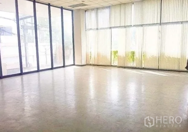 Warehouse for rent in Bang Phli, Samut Prakan - Glass-fronted office or showroom area with floor-to-ceiling windows and vertical blinds.