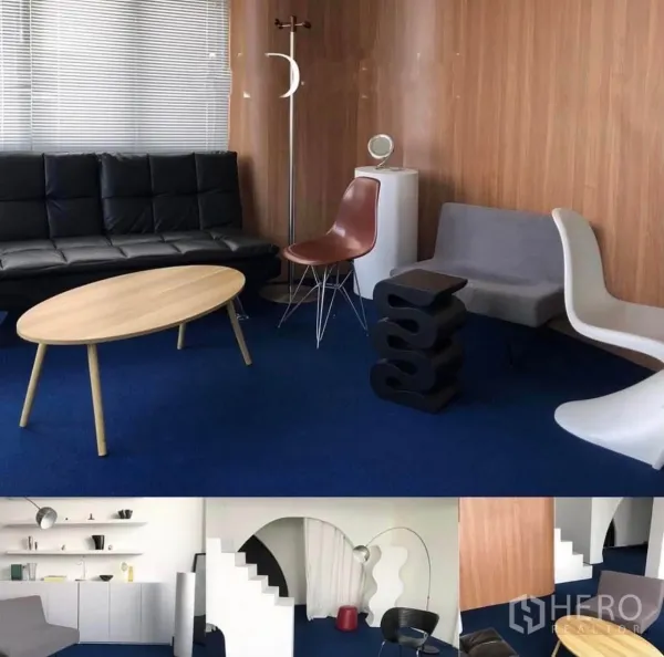 Shophouse for rent in Phra Khanong, Bangkok - Modern lounge area with blue carpet, wood wall panels, sofa, and assorted designer chairs.