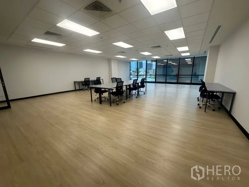 Office Space for rent in Chatuchak, Bangkok - Bright open-plan office with LED lights, light wood floors and city-view windows.
