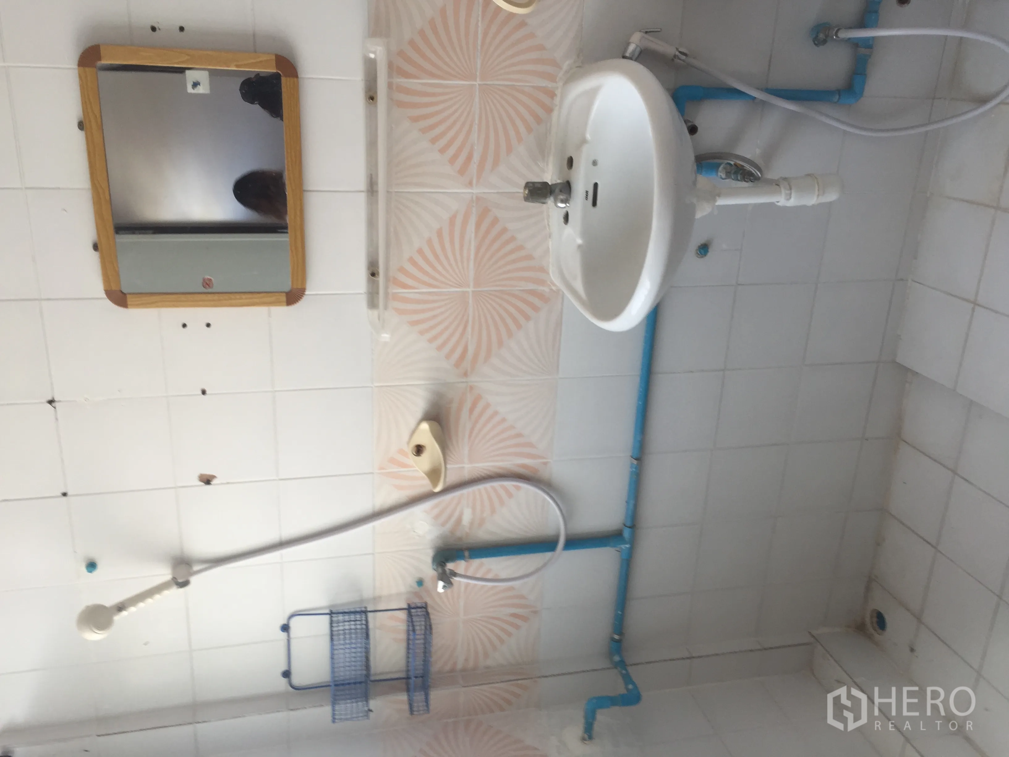 Home Office for rent in Watthana, Bangkok - White-tiled bathroom with shower, sink and wall mirror.