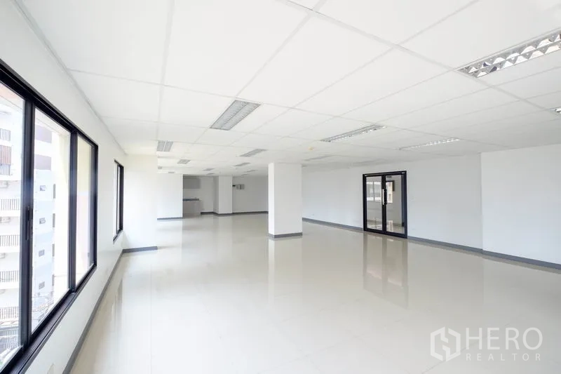 Office Space for rent in Chatuchak, Bangkok - Spacious open‑plan office with drop ceiling, tiled floors, and large windows.