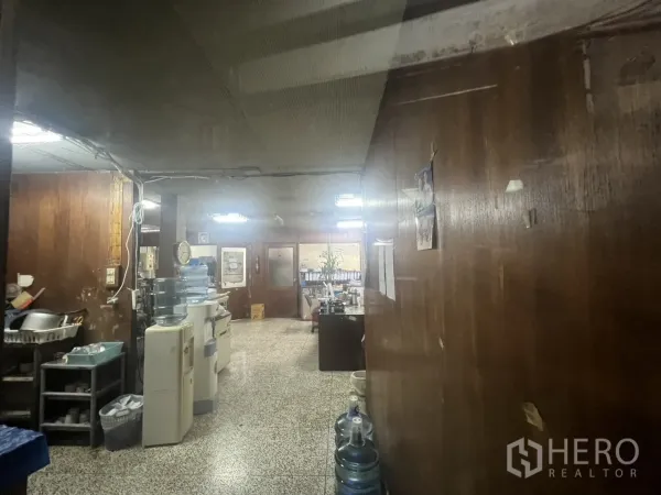 Shophouse for rent - Back-of-house workspace with wood-paneled walls, equipment and terrazzo floor.