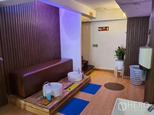 Shophouse for rent in Watthana, Bangkok - Foot-wash station with bench and two basins in a spa-style interior.