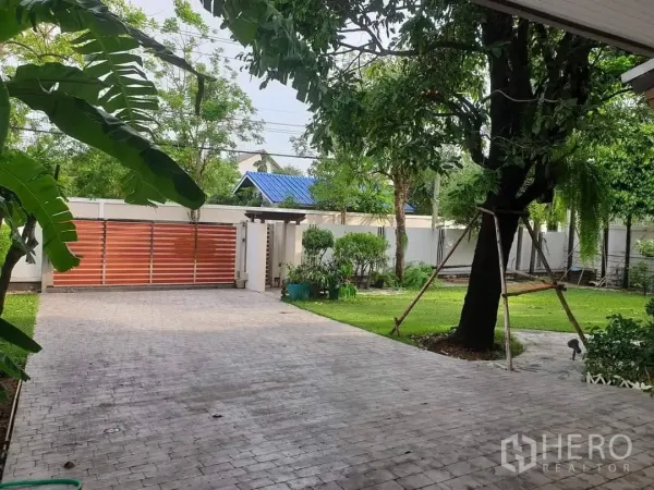 Detached House for rent in Bang Kapi, Bangkok - Wide paved driveway with sliding gate and mature garden.