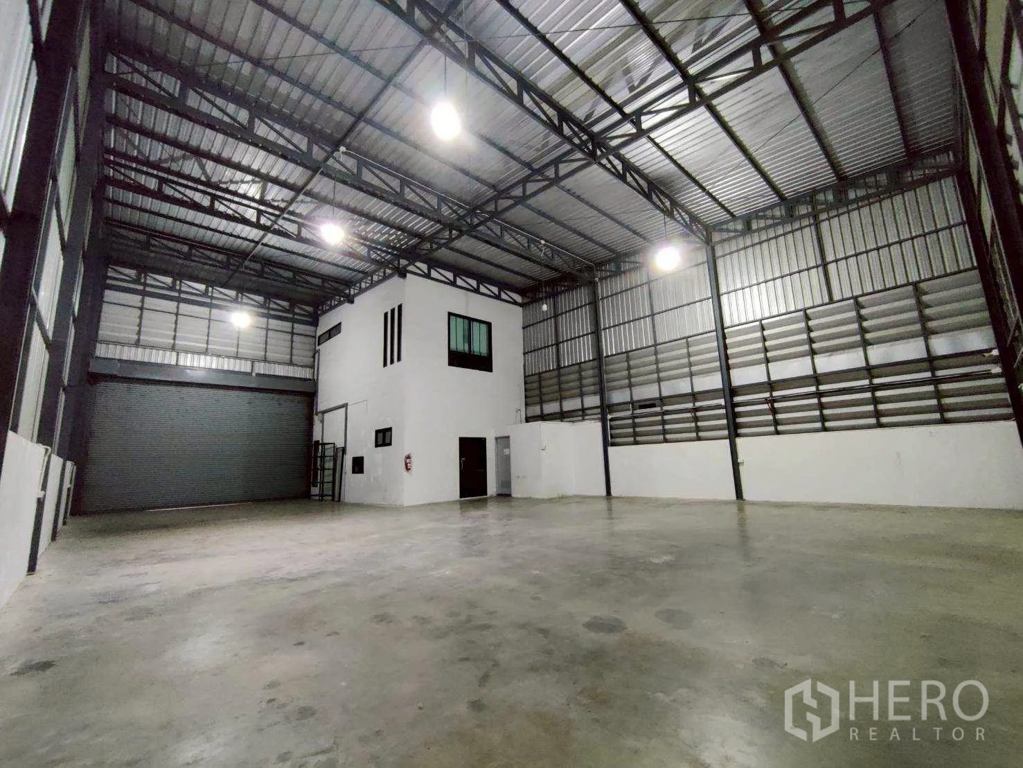 仓库 for rent in Lam Luk Ka, Pathum Thani - 正立面突出展示卷门与办公室窗户。