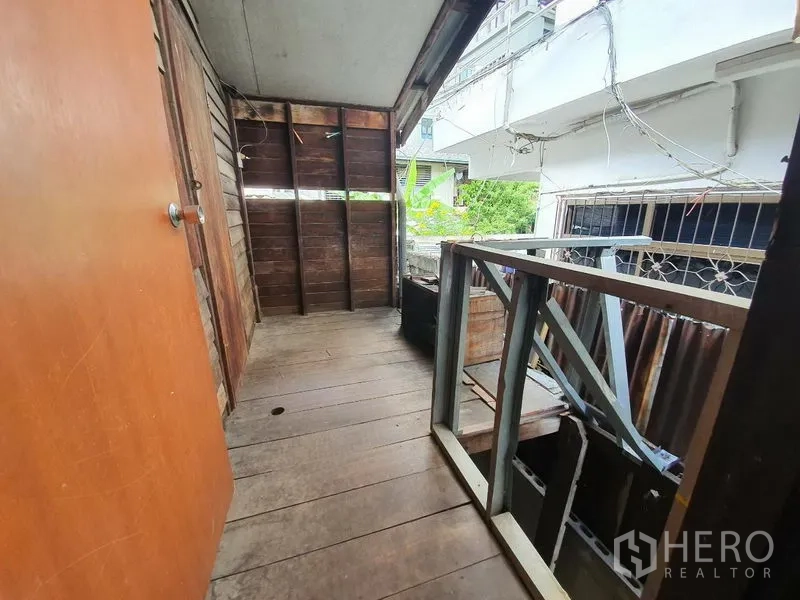 Detached House for rent in Sathon, Bangkok - Narrow covered balcony with timber floor and metal railing overlooking the lane.