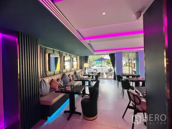 Retail Space for rent - Banquette seating with cushions, mirrored wall panels and floor-to-ceiling windows facing the street.