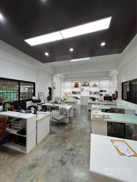 Warehouse for sale in Bang Bua Thong, Nonthaburi - Bright open-plan office with multiple desks, shelves and polished concrete floor.