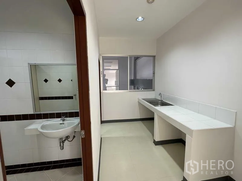 Factory for rent in Bang Phli, Samut Prakan - Pantry with stainless sink next to tiled restroom inside the office area.