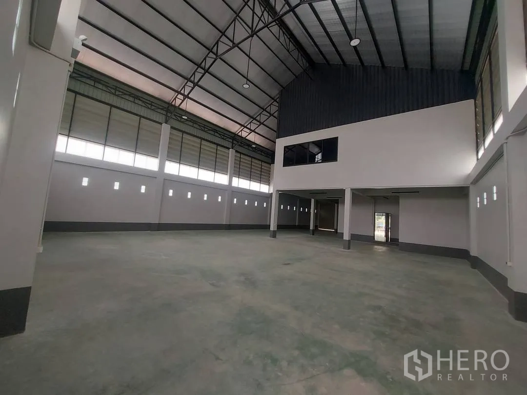 Factory for rent in Krathum Baen, Samut Sakhon - Wide warehouse floor with tall roof and an internal two-story office block.