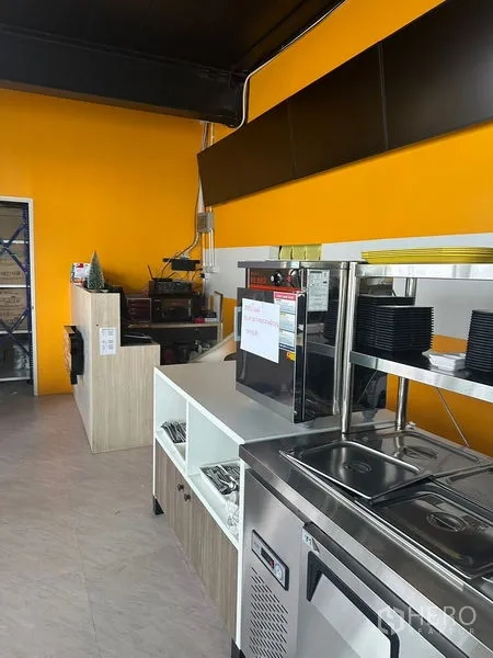 Retail Space for rent in Khlong Toei, Bangkok - Front prep counter with stainless equipment, shelving and bright feature wall.