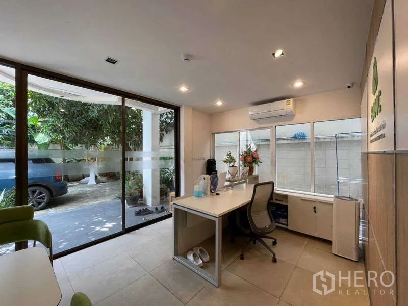 Home Office for rent in Watthana, Bangkok - Reception desk facing driveway with large sliding glass doors.