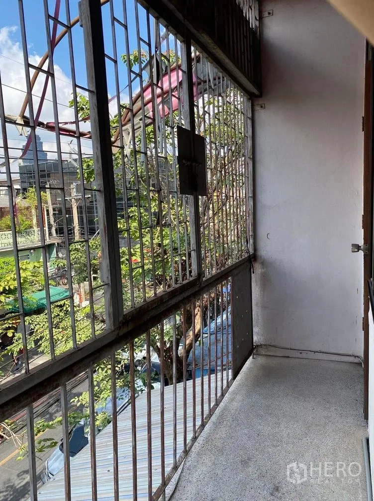 Retail Space for rent in Sathon, Bangkok - Narrow balcony with safety grilles overlooking a leafy neighborhood street.