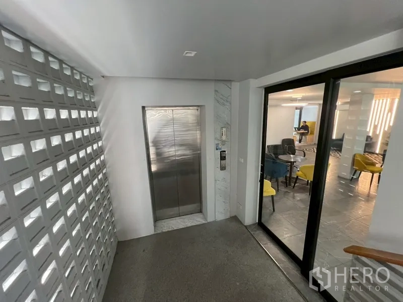 Home Office for rent or sale in Phra Khanong, Bangkok - Elevator lobby beside glass door to lounge area.