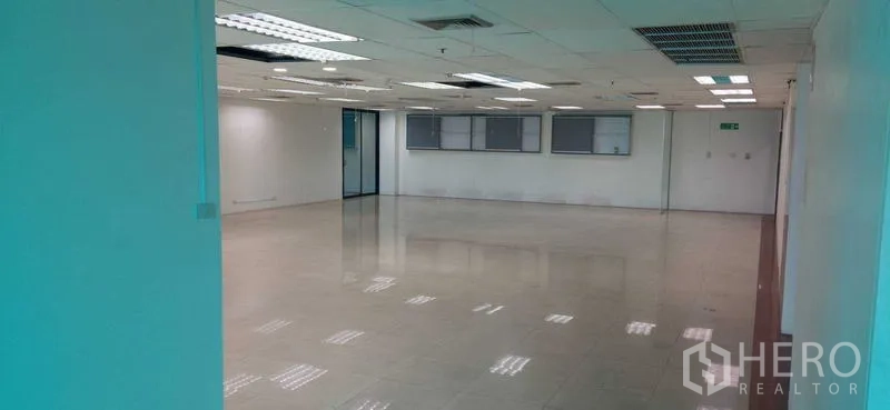 Office Space for rent in Huai Khwang, Bangkok - Reverse view of bright office space with air-conditioning vents, white walls and access doors.