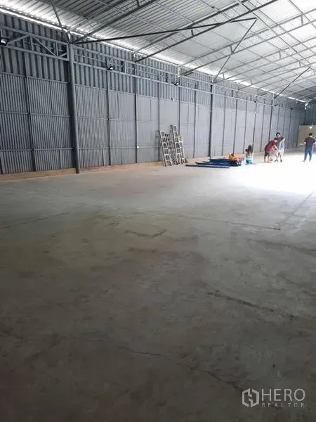 Warehouse for rent in Sathon, Bangkok - Spacious warehouse interior with high steel truss roof, concrete floor and metal wall cladding.
