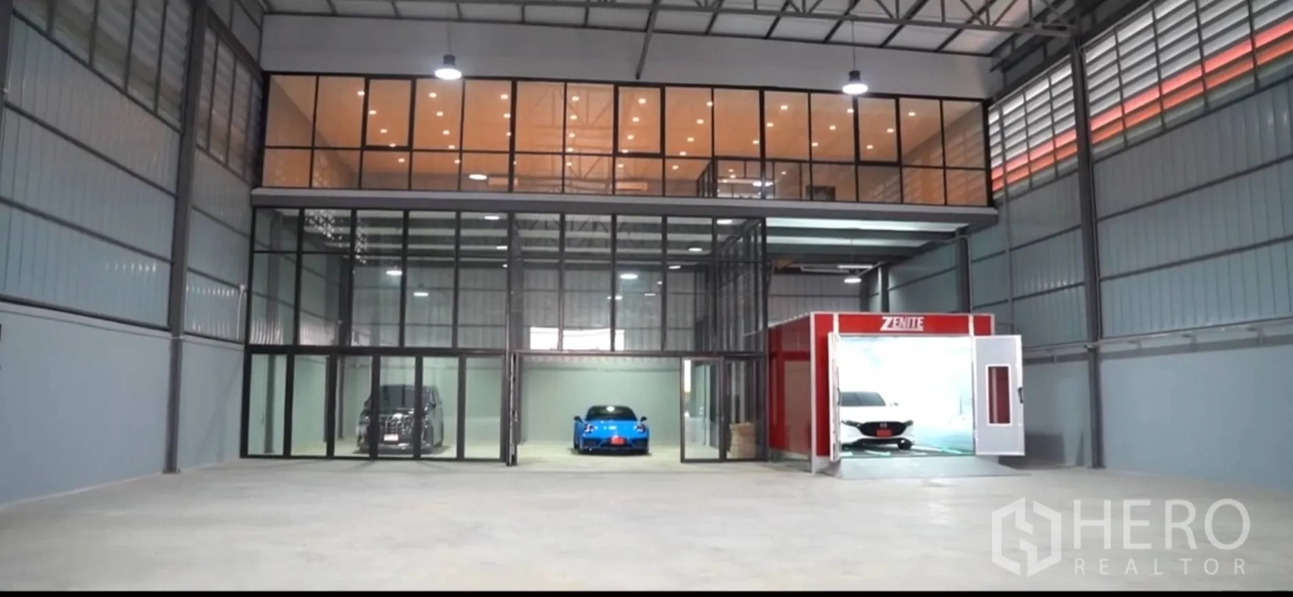 Warehouse for rent in Sai Mai, Bangkok - Warehouse interior with glass-fronted mezzanine offices and an enclosed spray booth.