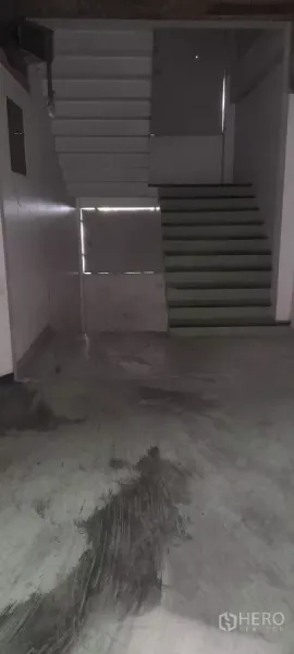 Retail Space for rent in Bang Na, Bangkok - Stairwell with twin flights connecting levels inside a bare commercial interior.