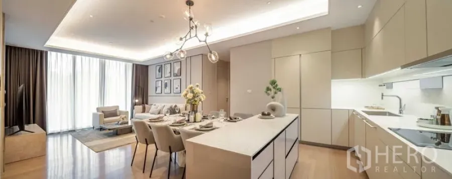 Condominium for sale in Pathum Wan, Bangkok - Wide view of the kitchen island, dining zone and sunlit living space.
