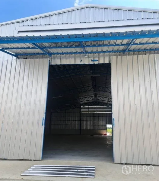 Warehouse for rent in Nong Chok, Bangkok - Front entrance of the warehouse showing large sliding doors and a drive-in loading area.