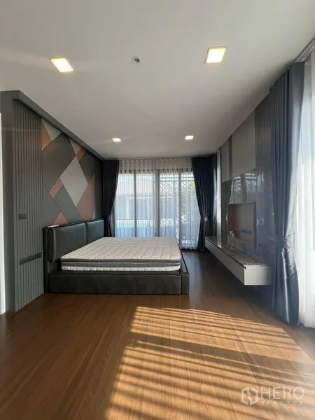 Detached House for rent or sale - Spacious master bedroom with feature wall, balcony doors and wood flooring.