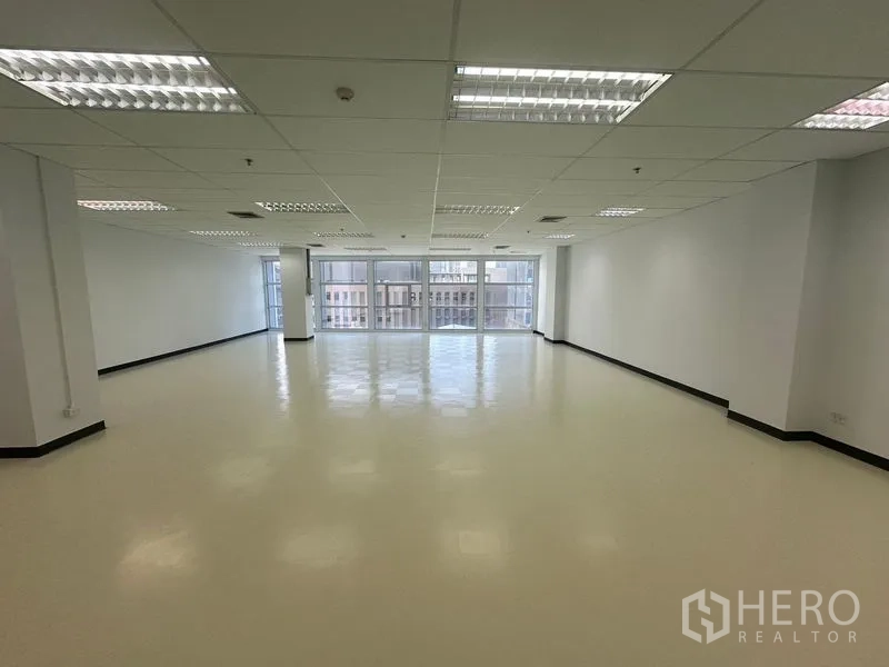 Office Space for rent in Bang Na, Bangkok - Open workspace facing floor-to-ceiling glazing and urban skyline.