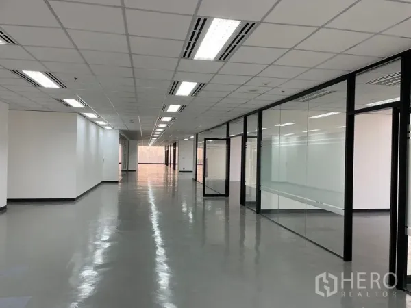 Office Space for rent in Din Daeng, Bangkok - Work area lined with black-framed glass offices and polished floors.