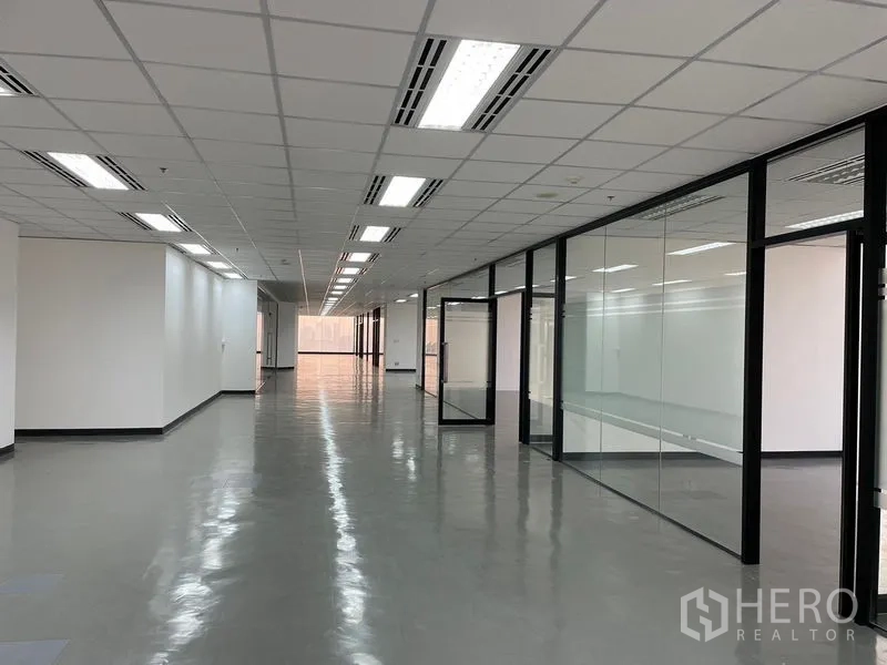 Office Space for rent in Din Daeng, Bangkok - Work area lined with black-framed glass offices and polished floors.