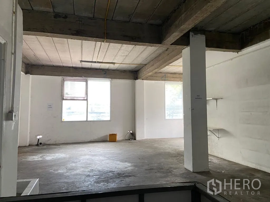 Retail Space for rent in Khlong Toei, Bangkok - Wide unfinished area with columns, exposed beams and multiple windows.