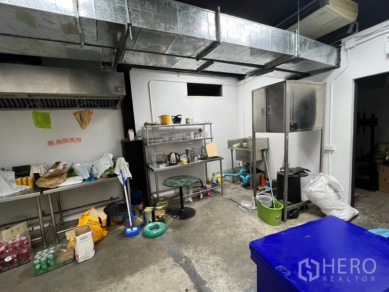 Retail Space for rent in Watthana, Bangkok - Back-of-house prep room with ventilation ducts, stainless counters, and storage.