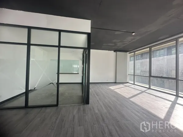 Office Space for rent in Khlong Toei, Bangkok - Glass meeting room with frosted panels beside bright corner windows and city views.
