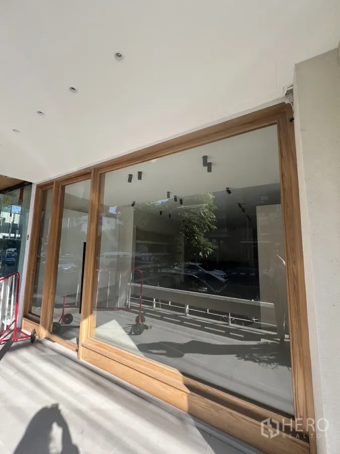 Retail Space for rent in Bangkok - Street-level retail facade with floor-to-ceiling glass and wood frame in Thonglor