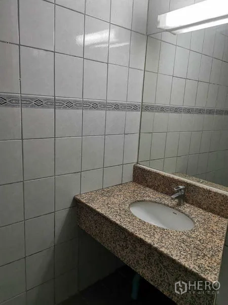 Office Space for rent in Watthana, Bangkok - Tiled restroom with granite vanity, sink and mirror.