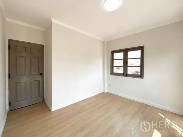 Detached House for rent or sale - Bright bedroom with wood floors, grey door and double casement window.