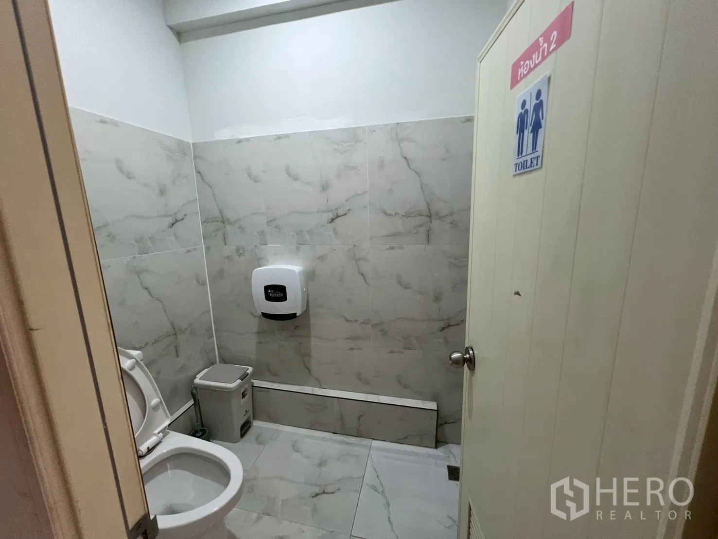 Retail Space for rent in Watthana, Bangkok - Second restroom with marble-style tiles and toilet fixtures.