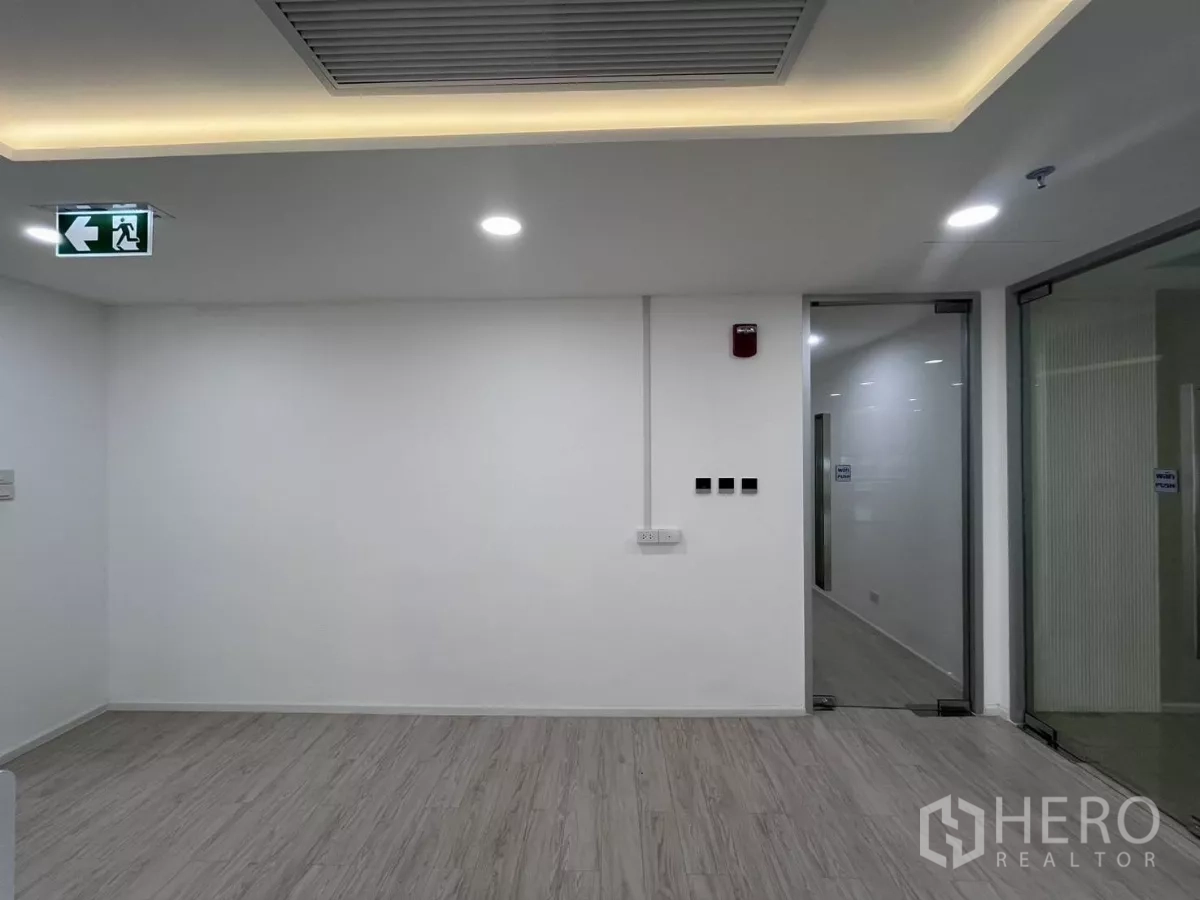 Office Space for rent in Din Daeng, Bangkok - Minimal lobby area with recessed ceiling lights, exit sign and glass doors.