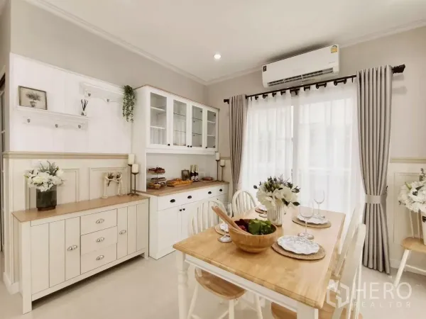 Detached House for rent in Khlong Luang, Pathum Thani - Close-up of dining space with built-in cabinet, table setting and air conditioner