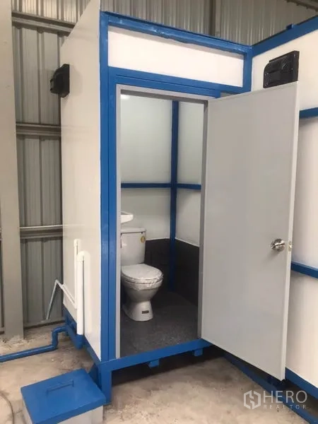 Warehouse for rent in Lat Phrao, Bangkok - Close-up of clean restroom with toilet inside the warehouse office module.