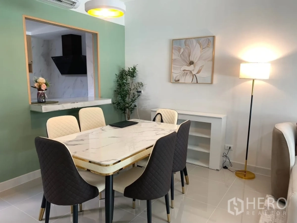 Townhouse for rent in Bang Phli, Samut Prakan - Dining area with marble-top table for six beside a serving window to the kitchen.
