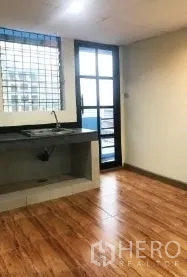 办公空间 出租在Bang Rak, Bangkok - 茶水间配水槽，木纹地砖，带格栅窗与阳台门。