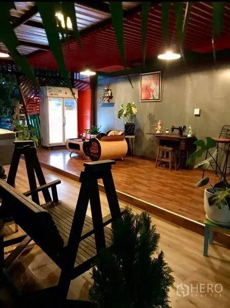 Warehouse for rent in Thanyaburi, Pathum Thani - Warm reception lounge with wood flooring, concrete walls, hanging lights and indoor plants beside the warehouse office.