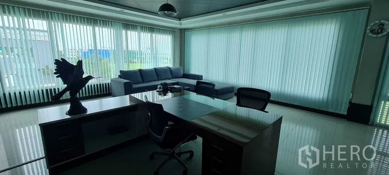 Warehouse for rent or sale in Bang Phli, Samut Prakan - Spacious office with light wood cabinetry, work desk, and sofa seating.