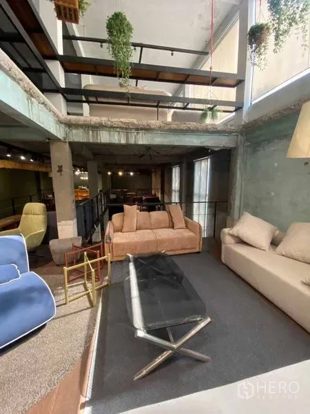 Retail Space for rent in Bang Na, Bangkok - Loft-style retail showroom with mezzanine, sofas and hanging plants