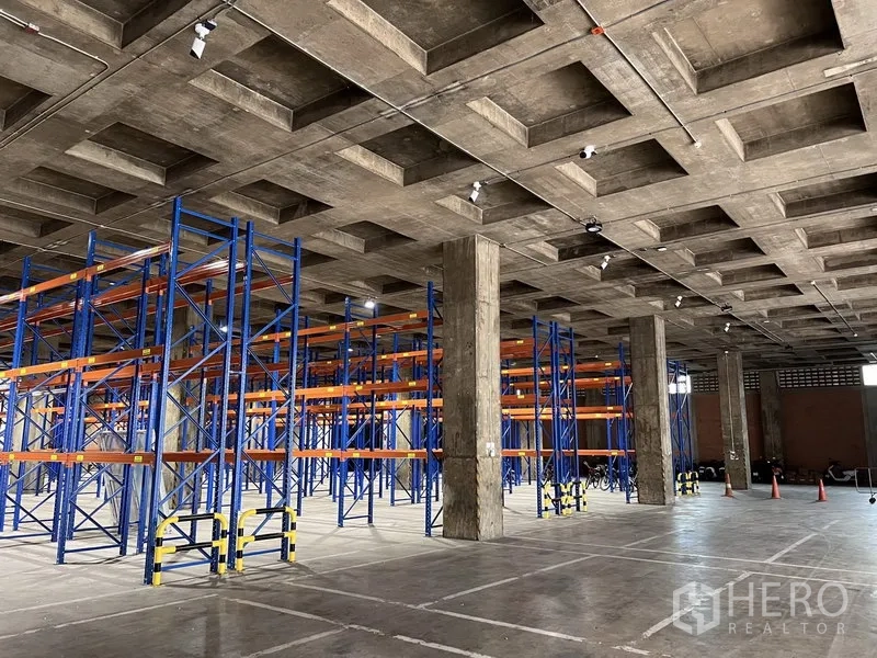 Warehouse for rent in Chatuchak, Bangkok - Open warehouse floor with racking system, LED lighting, and marked drive lanes in Bangkok.
