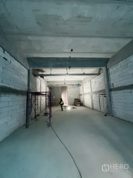 Retail Space for rent in Khlong Toei, Bangkok - Open retail interior looking toward the rear service area, unfinished concrete floor and walls.