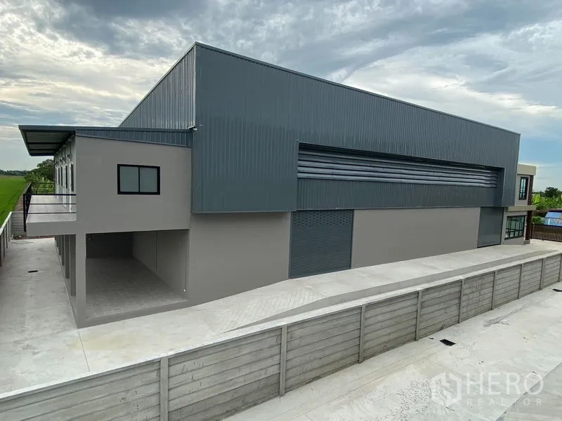 Warehouse for rent or sale in Bang Len, Nakhon Pathom - Metal-clad warehouse exterior with large roller shutter and loading area.
