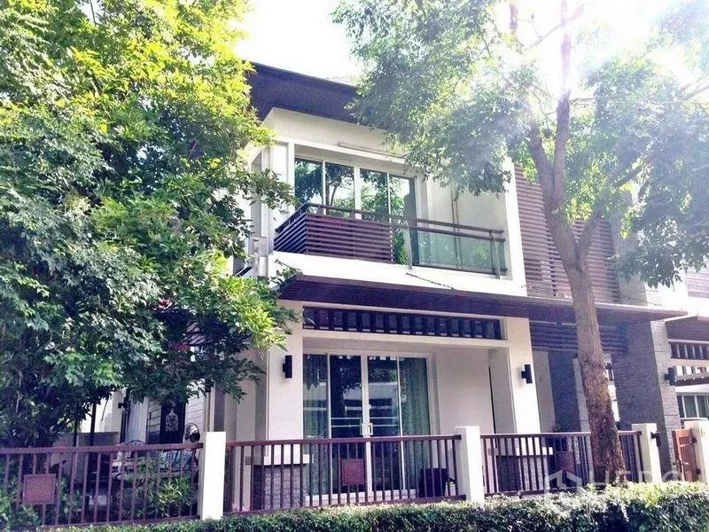 Detached House for rent or sale in Prawet, Bangkok - Modern two-storey house exterior with balcony, trees, and front fence.