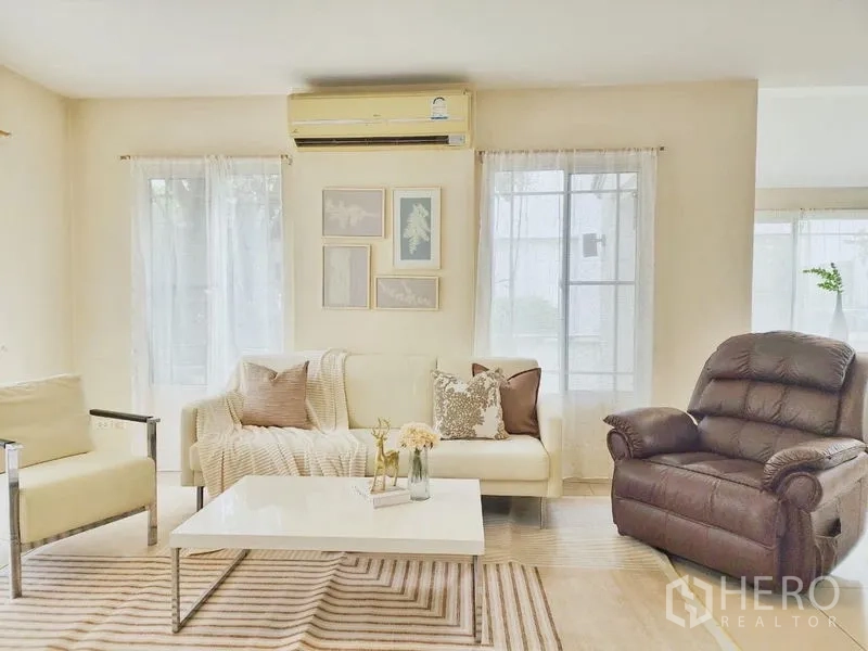 Detached House for rent in Prawet, Bangkok - Cozy living room with sofa set, recliner and coffee table under soft natural light.