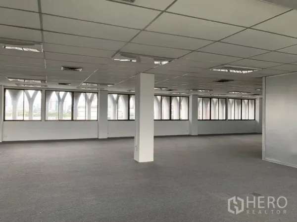 办公空间 出租在Ratchathewi, Bangkok - 拐角办公区域，宽幅窗户与外立面拱形框架，吊顶灯具齐全。